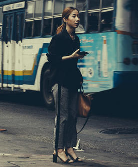 Girl standing by bus